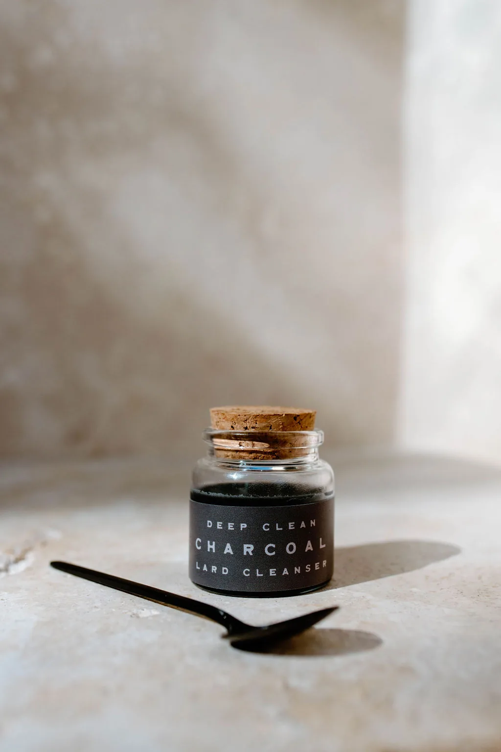 Deep Clean Charcoal lard cleanser in a corked glass jar