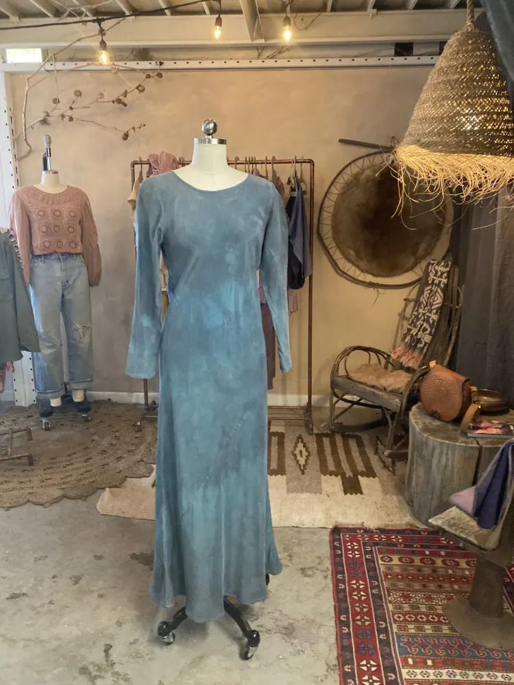 A woad-blue dress hanging in the shop